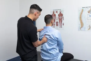 chiropractor assessing mid back posture and spinal alignment