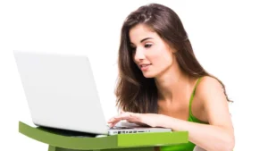 Woman sitting with improved posture while using a laptop at a desk