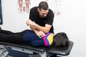 chiropractor performing thoracic spine adjustment for mid back pain